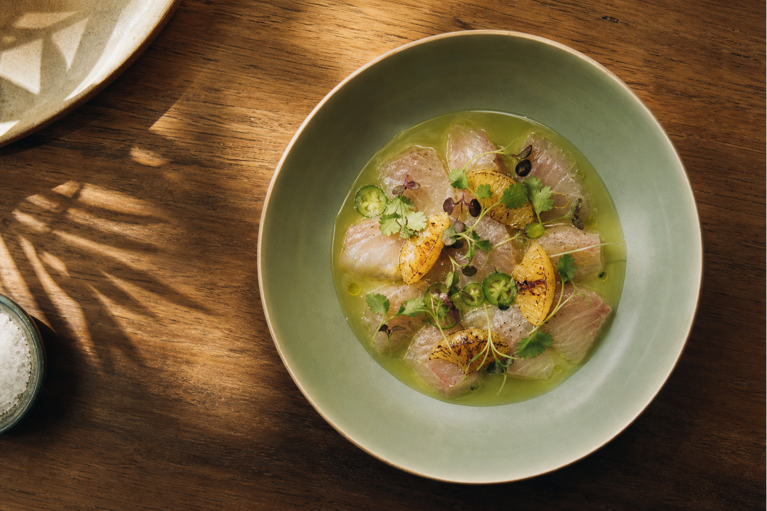 A Ballena gift card beside a crudo dish